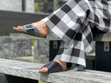 Quality European women's sandals. Made in Spain contoured cork footbed and rubber sole. Comfortable slide style sandal with cosmetic buckle detail. Birkenstock style sandal in black.