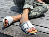 Quality European women's sandals. Made in Spain contoured cork footbed and rubber sole. Comfortable slide style sandal with cosmetic buckle detail. Birkenstock style sandal in brown.