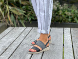 Comfortable women's slingback  sandals. European made in Spain. Soft quality leather straps with elastication and wedge rubber sole unit. In black.