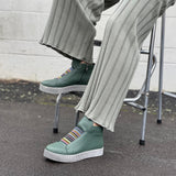 Forest green high-top sneakers with striped soles. Comfortable women's sneakers and boots.
