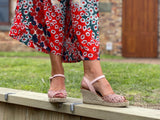 Pink Viguera Volco sandals with a floral woven detail and an ankle strap with a buckle closure. The sandals have a natural woven jute wedge sole. Quality and comfortable European sandals.
