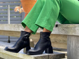 Black women's ankle boots, European made in Portugal. Mid heel height with zipper entry. Quality leather uppers, comfortable dress boot with a square toe.